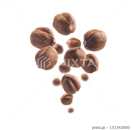 Peeled hazelnut levitates on a white background Peeled hazelnut levitates on a white background 131342600