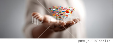 Open hand of a businessman holding numerous national flags, symbolizing international business, fostering global communication, and promoting world partnership across diverse cultures Open hand of a businessman holding numerous national flags, symbolizing international business, fostering global communication, and promoting world partnership across diverse cultures 131343147