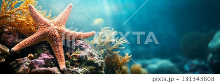 Starfish rests on a colorful coral reef, surrounded by lush marine plants. Sunlight filters through the water, creating a serene underwater scene full of life and natural beauty 131343808