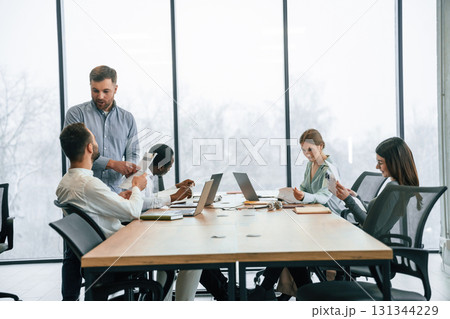 Bunch of laptops on the table. Team of office workers are together indoors 131344229