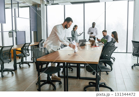 Team of office workers are together indoors 131344472