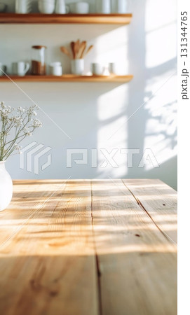 Sunlight streaming through a window, illuminating an empty wooden table adorned with white flowers in a vase, set against a backdrop of modern kitchen shelves and kitchenware Sunlight streaming through a window, illuminating an empty wooden table adorned with white flowers in a vase, set against a backdrop of modern kitchen shelves and kitchenware 131344765