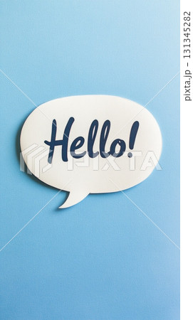 White speech bubble with the word hello written in blue sits on a light blue background, representing communication, greeting, and online messaging 131345282