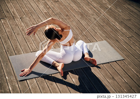 Professional yoga practitioner. Young woman in fitness clothes is outdoors 131345427