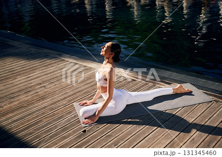 Young woman in fitness clothes is outdoors Young woman in fitness clothes is outdoors 131345460