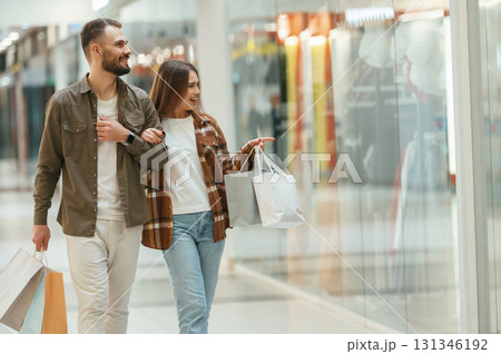 Walking, looking at products. Young couple are in supermarket together Walking, looking at products. Young couple are in supermarket together 131346192