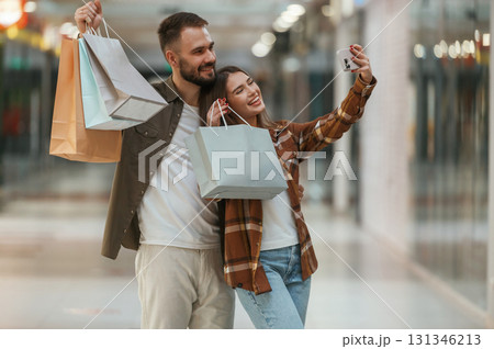 Making selfie. Young couple are in supermarket together Making selfie. Young couple are in supermarket together 131346213