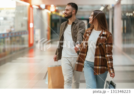 Together, holding hands. Young couple are in supermarket Together, holding hands. Young couple are in supermarket 131346223