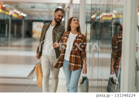 Together, holding hands. Young couple are in supermarket Together, holding hands. Young couple are in supermarket 131346224
