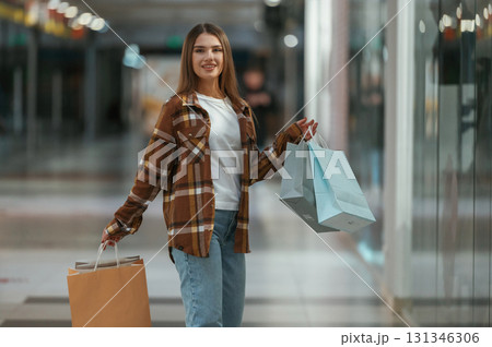 In the corridor. Woman is shopping in the supermarket 131346306