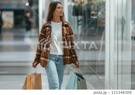 In the corridor. Woman is shopping in the supermarket 131346309