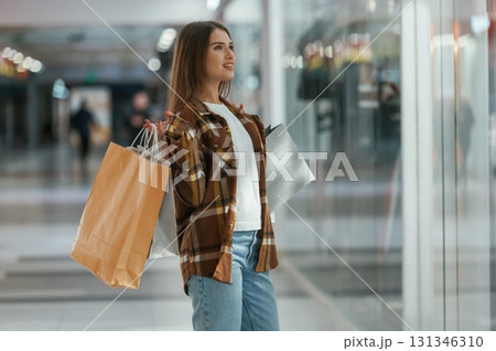 In the corridor. Woman is shopping in the supermarket 131346310