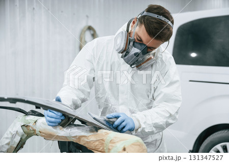 Metal carcass. Repairman is working in the garage 131347527