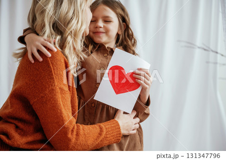 Conception of mother's day celebration. Parent with daughter at home 131347796