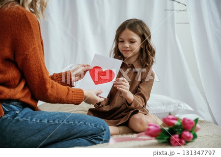 Conception of mother's day celebration. Parent with daughter at home Conception of mother's day celebration. Parent with daughter at home 131347797