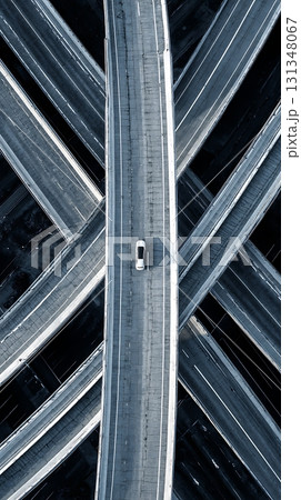 Aerial View Lone Car on a Multilevel Highway Interchange Aerial View Lone Car on a Multilevel Highway Interchange 131348067
