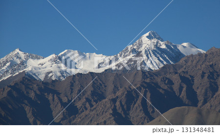 Snow covered peaks of the Zanskar Range, seen from Leh, India. 131348481