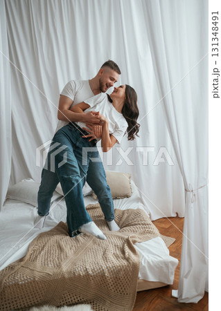In casual clothes, embracing each other. Young couple are together at home 131348491