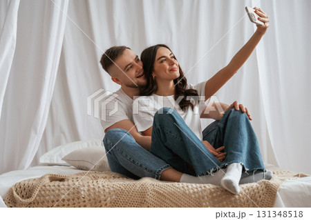Doing selfie. Young couple are together at home Doing selfie. Young couple are together at home 131348518