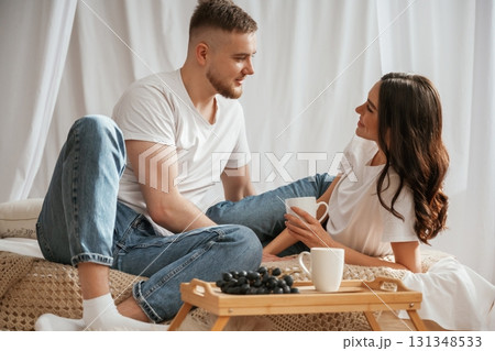Grape and cups of drink. Young couple are together at home 131348533