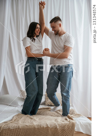 Standing and playing on the bed. Young couple are together at home 131348574