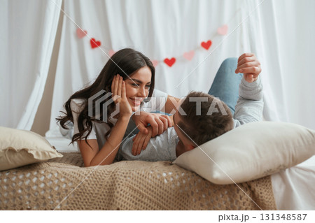Together on the bed. Young couple are at home 131348587