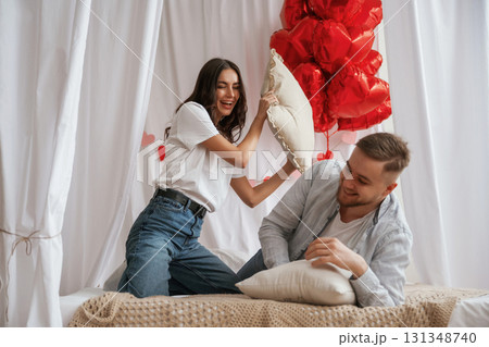 Background with red festive decorations for Valentine's day. Young couple are together at home 131348740