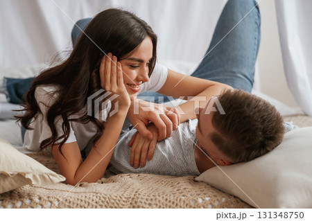 Together on the bed. Young couple are at home 131348750