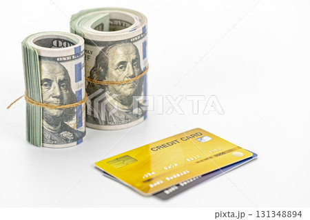 Rolled cash and credit card on white background, financial concept showing money and payment card conveying success and transaction confidence Rolled cash and credit card on white background, financial concept showing money and payment card conveying success and transaction confidence 131348894