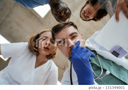 Conception of curiosity. View from below of group of doctors 131349001