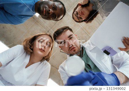 Conception of curiosity. View from below of group of doctors 131349002