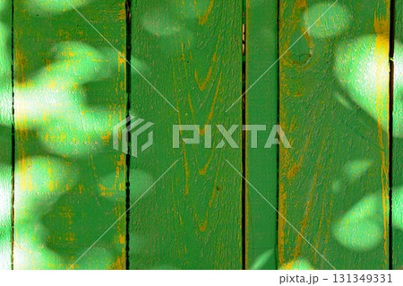 A green wooden fence with a yellow stripe 131349331