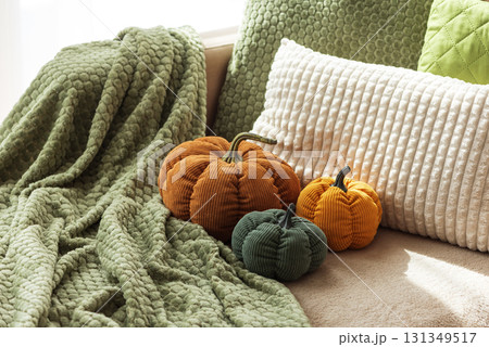 Cozy Autumn Sofa with Fabric Pumpkins and Textured Pillows 131349517