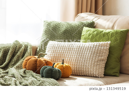 Cozy Autumn Sofa with Fabric Pumpkins and Textured Pillows Cozy Autumn Sofa with Fabric Pumpkins and Textured Pillows 131349519
