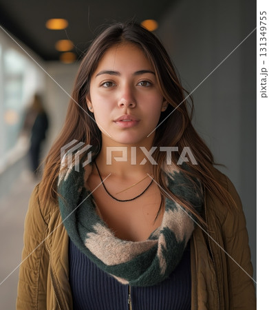 A woman wearing a green and brown scarf and a brown jacket 131349755