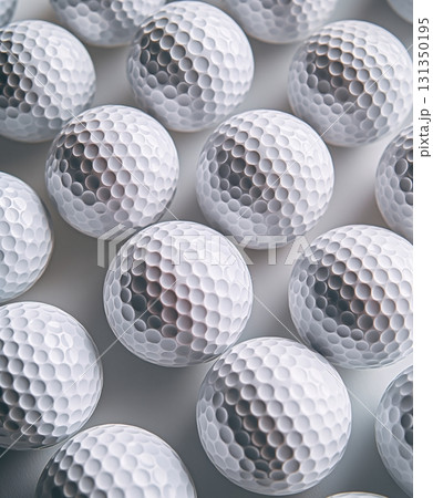A row of golf balls are lined up on a white surface A row of golf balls are lined up on a white surface 131350195