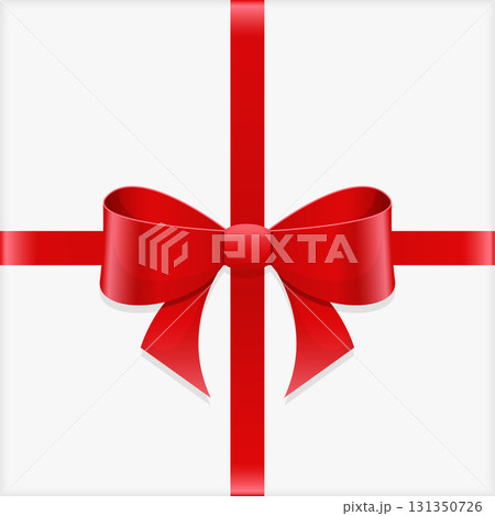 A gift wrapped in plain white paper is tied with a vibrant red ribbon and matching bow. 131350726