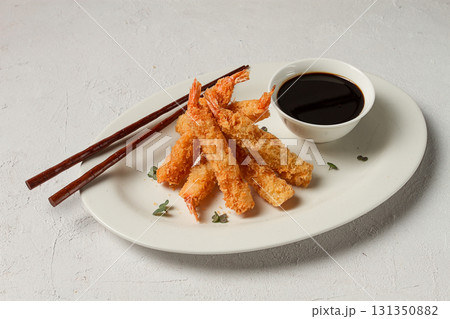 Fried shrimp, peeled in tempura, soy sauce, close-up, 131350882