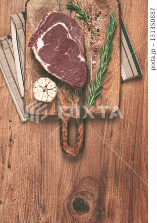 raw steak, beef steak, rib eye steak, on a cutting board, freshly frozen, on the table, top view, raw steak, beef steak, rib eye steak, on a cutting board, freshly frozen, on the table, top view, 131350887