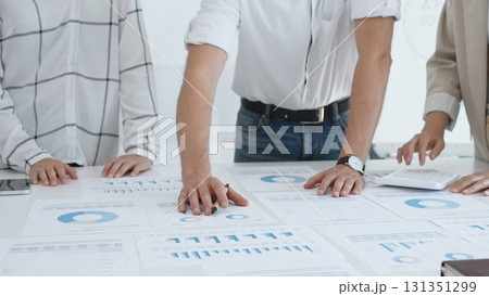 Professional team reviewing financial charts, working together in contemporary workspace, brainstorming strategic improvements. Business people concept Professional team reviewing financial charts, working together in contemporary workspace, brainstorming strategic improvements. Business people concept 131351299