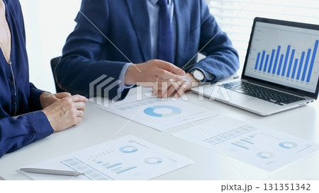 Business people reviewing financial data, discussing and shared documents during collaborative strategy session. Audit and finance concept Business people reviewing financial data, discussing and shared documents during collaborative strategy session. Audit and finance concept 131351342