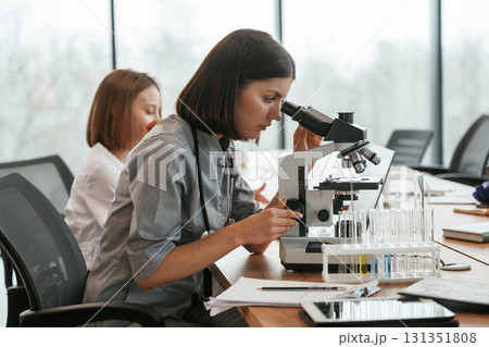 View from the side. Two female doctors are working indoors together 131351808