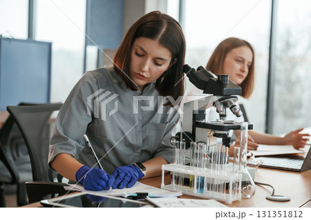 Two female doctors are working indoors together Two female doctors are working indoors together 131351812