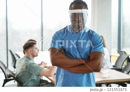 Black guy is in the protective mask. Group of doctors are together indoors 131351873