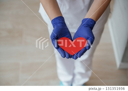 Female doctor is holding heart shaped paper, conception of cardiology 131351936