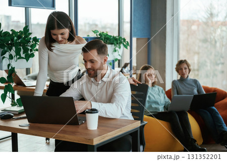 People are working in the office with bean bags chairs in it People are working in the office with bean bags chairs in it 131352201