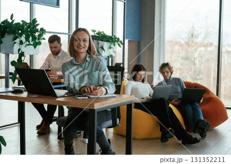 Positive and cheerful mood. People are working in the office with bean bags chairs in it Positive and cheerful mood. People are working in the office with bean bags chairs in it 131352211