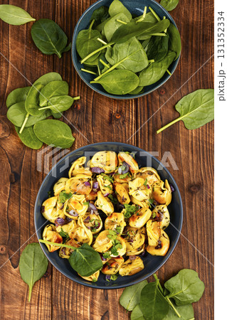 A plate of ravioli filled with a green spinach. A plate of ravioli filled with a green spinach. 131352334