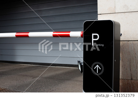 Parking gate with red and white barrier arm and Parking sign. This image highlights modern urban infrastructure and convenience of parking systems 131352379