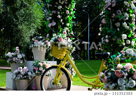 Urban cycling scene with yellow bicycle surrounded by flowers, symbolizing modern city life, eco friendly transportation, and the connection between nature and urban living Urban cycling scene with yellow bicycle surrounded by flowers, symbolizing modern city life, eco friendly transportation, and the connection between nature and urban living 131352383